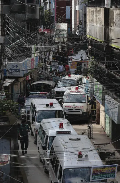 Ambulances carrying bodies of killed suspected Islamic militants leave the premises of a five-story building that was raided by police in Dhaka, Bangladesh, Tuesday, July 26, 2016. (Photo by AP Photo)