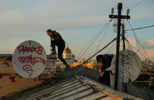 Georgy Lanchevskiy (L) and Konstantin Drykin of Rudex climb across a rooftop in Moscow, Russia, June 2, 2017. (Photo by Maxim Shemetov/Reuters)