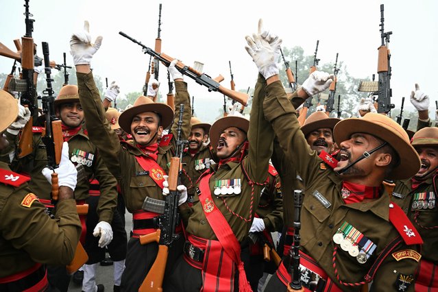 Indian army soldiers dance to the tunes of a military band as they take a break during rehearsals for the upcoming Republic Day parade on a cold winter morning in New Delhi on January 3, 2025. (Photo by Money Sharma/AFP Photo)