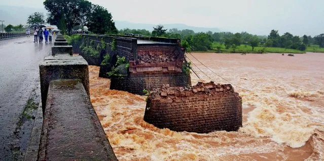 The remaining portion of Mahad-Poladpur bridge which was washed away in flood water of Savitri river on the Mumbai-Goa highway in Raigad district, Maharashtra,  India on Wednesday, August 3, 2016. (Photo by Press Trust of India)