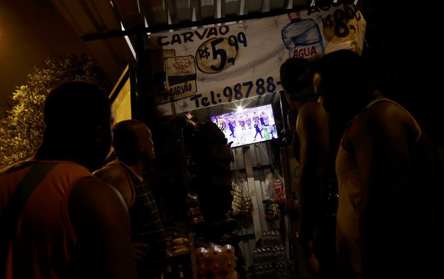 2016 Rio Olympics, Opening Ceremony, Maracana, Rio de Janeiro, Brazil on August 5, 2016. Residents of Mangueira favela watch the opening ceremony on TV. (Photo by Ricardo Moraes/Reuters)