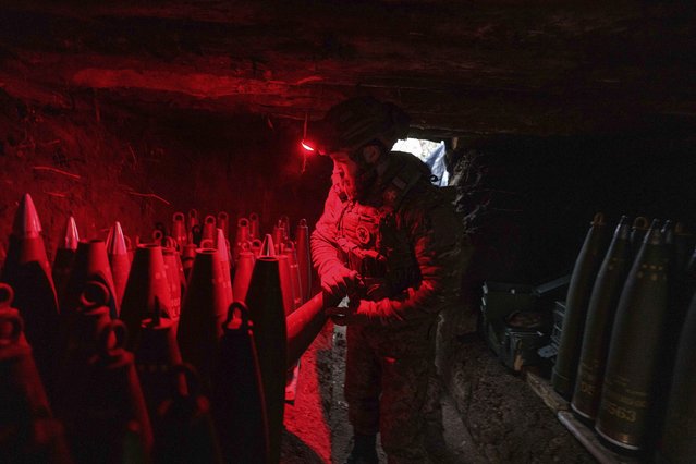 A Ukrainian serviceman of the 148th artillery brigade prepares 155mm artillery shells for a M777 howitzer before firing towards Russian positions at the frontline on Velyka Novosilka direction, Donetsk region, Ukraine, January 26, 2025. (Photo by Evgeniy Maloletka/AP Photo)