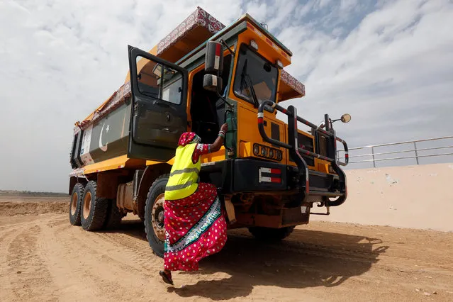 Gulaban, 25, mother of three, climbs into a 60-tonne truck, during a training session of the Female Dump Truck Driver Programme, held by the Sindh Engro Coal Mining Company (SECMC), in Islamkot, Tharparkar, Pakistan September 21, 2017. (Photo by Akhtar Soomro/Reuters)