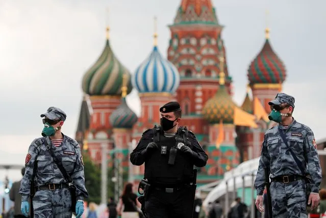 Russian law enforcement officers wearing protective face masks, used as a preventive measure against the spread of the coronavirus disease (COVID-19), walk at the annual Red Square Book Fair in central Moscow, Russia on June 6, 2020. (Photo by Shamil Zhumatov/Reuters)