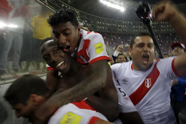 Peru's players celebrate after a play-off qualifying match for the 2018 Russian World Cup against New Zealand in Lima, Peru, Wednesday, November 15, 2017. Peru beat New Zealand 2-0 to win a two-leg playoff and earn the 32nd and last spot in the World Cup field in Russia. (Photo by Rodrigo Abd/AP Photo)