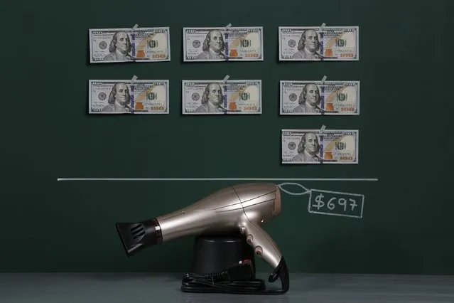 A hair dryer as photographed in a studio with an illustrative price tag of $697 (US dollars), equivalent to the Bs. 4,392 (bolivars) that it costs on average to purchase in Caracas at the official exchange rate of 6.3 bolivars per dollar, in Caracas September 29, 2014. (Photo by Carlos Garcia Rawlins/Reuters)