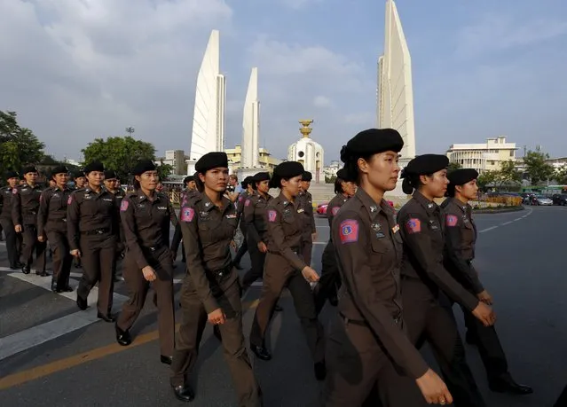 Police officers patrol around the Democracy Monument before demonstrators from the New Democracy Movement (NDM) group rally in Bangkok, Thailand, September 19, 2015. Hundreds of activists defied a ban on protests and marched in Thailand's capital on Saturday in a rare rally against the hard-line ruling military. (Photo by Chaiwat Subprasom/Reuters)