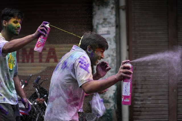 Indians play with colours as they celebrate Holi in Jammu, India, Friday, March 14, 2025. (Photo by Channi Anand/AP Photo)