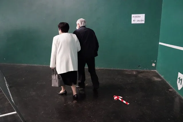 A couple leaves after voting during the Basque regional elections, amid the coronavirus disease (COVID-19) outbreak, in Ordizia, Spain on  July 12, 2020. (Photo by Vincent West/Reuters)