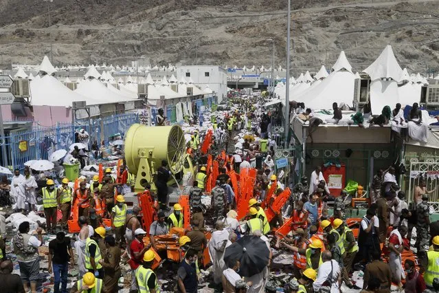 Muslim pilgrims and rescuers gather around people who died in Mina, Saudi Arabia during the annual hajj pilgrimage on Thursday, September 24, 2015. (Photo by AP Photo)