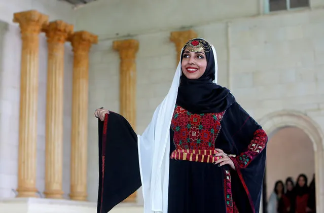 A Palestinian model displays a traditional Palestinian dress during a fashion show in celebration of Palestinian Traditional Dress and Heritage Day at Haddad village near the West Bank city of Jenin, July 25, 2016. (Photo by Abed Omar Qusini/Reuters)
