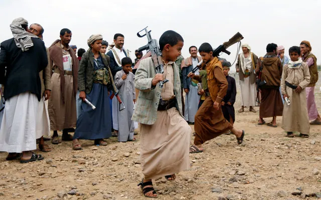 Armed boys perform the traditional Baraa dance as they attend a tribal gathering held by tribesmen loyal to the Houthi movement to show support to a political council formed by the movement and the General People's Congress party to unilaterally rule Yemen by both groups in Sanaa, August 14, 2016. (Photo by Khaled Abdullah/Reuters)