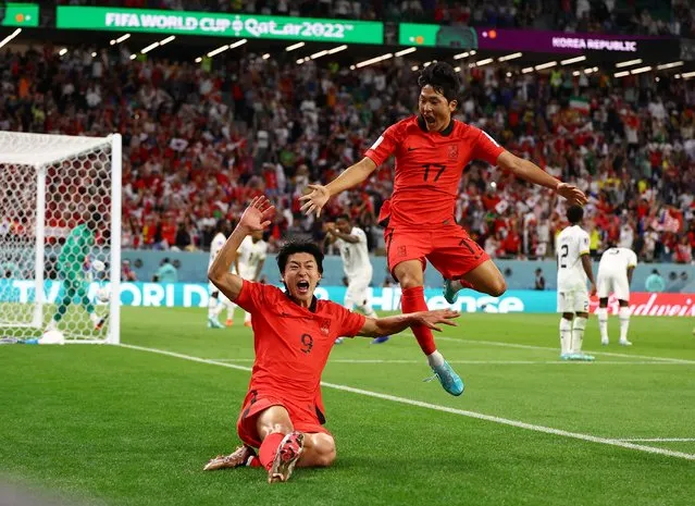 South Korea's Cho Gue Sung (9) and Na Sang Ho celebrate after Cho scores his second goal during the second half of a World Cup Group H football match against Ghana at Education City Stadium in Al Rayyan, Qatar, on November 28, 2022. (Photo by Kai Pfaffenbach/Reuters)