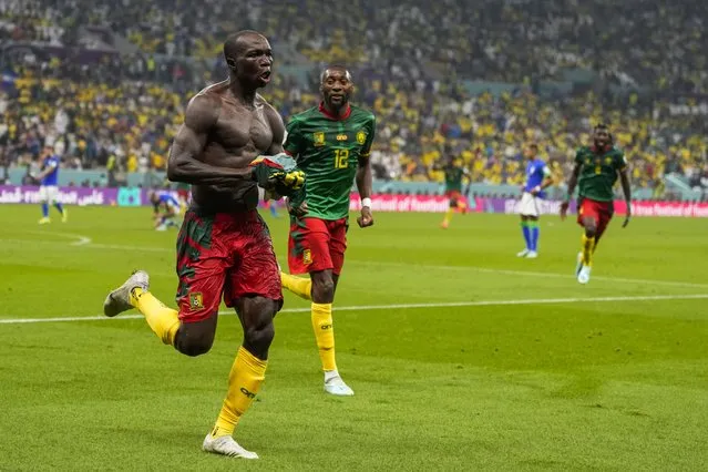 Cameroon's Vincent Aboubakar, left, celebrates after scoring the opening goal during the World Cup group G soccer match between Cameroon and Brazil, at the Lusail Stadium in Lusail, Qatar, Friday, December 2, 2022. (Photo by Andre Penner/AP Photo)