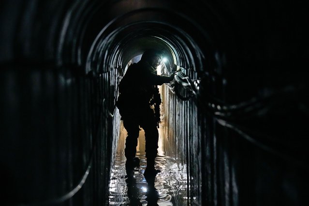 Lt. Col. Ido, whose last name was redacted by the military, walks inside a tunnel underneath the UNRWA compound, where the military discovered tunnels in the main headquarters of the U.N. agency that the military says Hamas militants used to attack its forces during a ground operation in Gaza, Thursday, February 8, 2024. The Israeli military says it has discovered tunnels underneath the main headquarters of the U.N. agency for Palestinian refugees in Gaza City, alleging that Hamas militants used the space as an electrical supply room. The unveiling of the tunnels marked the latest chapter in Israel's campaign against the embattled agency, which it accuses of collaborating with Hamas. (Photo by Ariel Schalit/AP Photo)