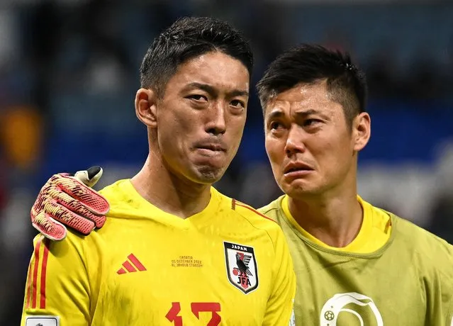 Japan's goalkeeper #12 Shuichi Gonda (L) and Japan's goalkeeper #01 Eiji Kawashima react to their team's defeat in the Qatar 2022 World Cup round of 16 football match between Japan and Croatia at the Al-Janoub Stadium in Al-Wakrah, south of Doha on December 5, 2022. (Photo by Dylan Martinez/Reuters)