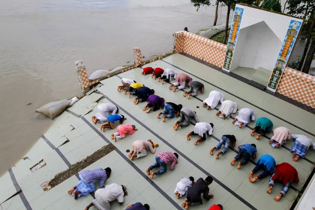 Bangladeshi people perform Eid al-Adha prayer in flood affected area near Dhaka, Bangladesh on August 01, 2020. (Photo by Stringer/Anadolu Agency via Getty Images)
