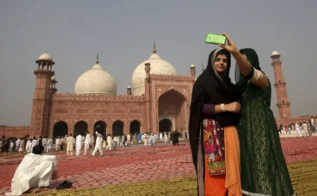 Muslims take a selfie before a mass prayer for Eid al-Adha at the Badshahi mosque in Lahore, Pakistan September 25, 2015. (Photo by Mohsin Raza/Reuters)