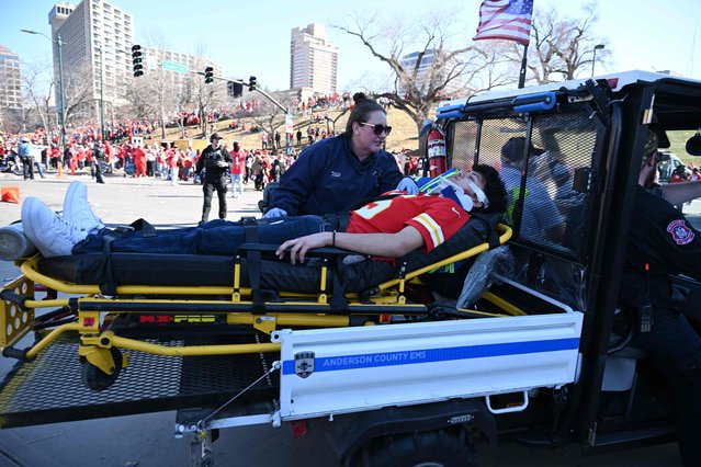 A victim is aided after shots were fired near the Kansas City Chiefs' Super Bowl LVIII victory parade on February 14, 2024, in Kansas City, Missouri. (Photo by Andrew Caballero-Reynolds/AFP Photo)
