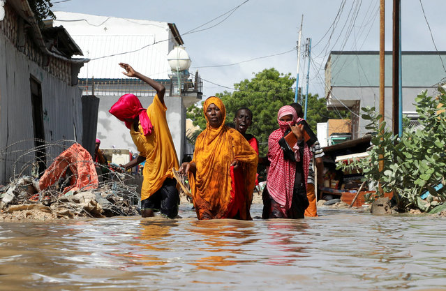 A Somali family wades through flood waters, as they flee after overnight rains destroyed their home, in Wadajir district of Mogadishu, Somalia on May 10, 2025. (Photo by Feisal Omar/Reuters)