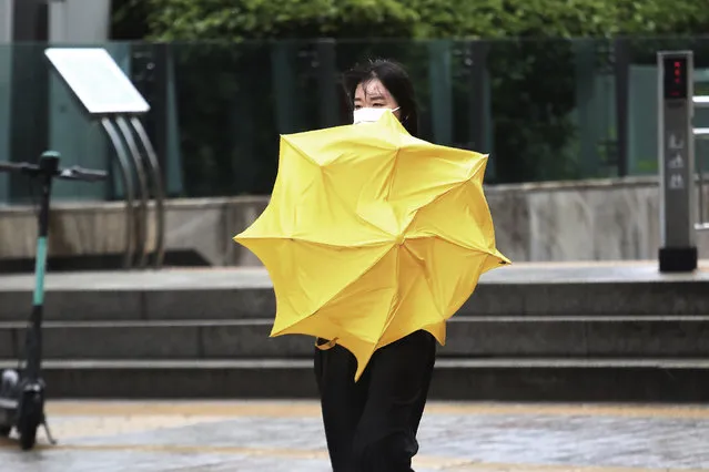 A woman holds an umbrella against the strong wind and rain caused by Typhoon Bavi in Seoul, South Korea, Thursday, August 27, 2020. Typhoon Bavi that grazed South Korea and caused some damage has made landfall in North Korea early Thursday. South Korean authorities said there were no immediate reports of casualties, and North Korea has not reported any damages. (Photo by Ahn Young-joon/AP Photo)