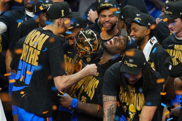 Luguentz Dort holds the Larry O'Brien Championship Trophy as the Oklahoma City Thunder celebrate their NBA title on Sunday, June 22, 2025. The Thunder defeated the Indiana Pacers in Game 7 of the Finals to cap off one of the winningest seasons in league history. (Photo by Nate Billings/AP Photo)