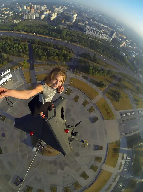 An astonishing set of snaps of a thrill-seeker's sky-high catwalk show on the edge of some of the world's tallest buildings has turned her into a social media sensation. Daredevil Angelina Nikolau, 23, from Russia, has spent weeks travelling around China and Hong Kong posing for jaw-dropping skyscraper selfies hundreds of feet above the ground. Her vertigo inducing results – uploaded to Instagram – have made her an instant star on the internet. Angelina is described by Russian media as “self-taught photographer, adventurer and roofer from Moscow”. Roofing – also known as rooftopping – is where people get as close as possible to the edge of a skyscraper's highest point to take selfies. (Photo by Kirill Oreshkin/CEN)