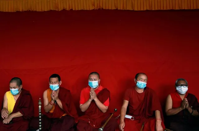 Buddhist monks wearing face masks offer prayer during the funeral procession of Ang Rita Sherpa, the first man to climb Mount Everest 10 times without the use of supplement oxygen, who was also known as the “snow leopard”, in Kathmandu, Nepal, September 23, 2020. (Photo by Navesh Chitrakar/Reuters)