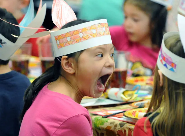 Rachael Bush a first grader at Pashley Elementary reacts to corn bread that was being served at a Thanksgiving feast at the school Tuesday morning, November 25, 2014, in Schenectady, N.Y. (Photo by Marc Schultz/AP Photo/The Daily Gazette)