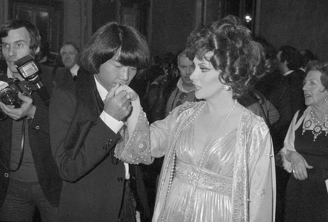 In this December 16, 1977 file photo, designer Kenzo Takada kisses the hand of Italian actress Gina Lollobrigida after she awarded him as one of the ten most elegant men in the world in Rome, Italy. Fashion designer Kenzo Takada dies from COVID-19 complications at age 81 near Paris, spokeswoman and reports said Sunday Oct. 4, 2020. (Photo by AP Photo/File)
