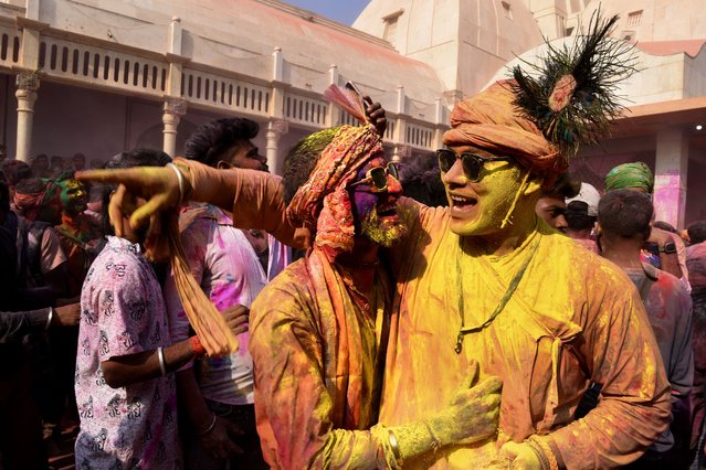 Villagers smeared with colors play Holi at Nandagram temple in Nandgoan village, 115 kilometers (70 miles) south of New Delhi, India, Wednesday, March 1, 2023. (Photo by Deepanshu Aggarwal/AP Photo)