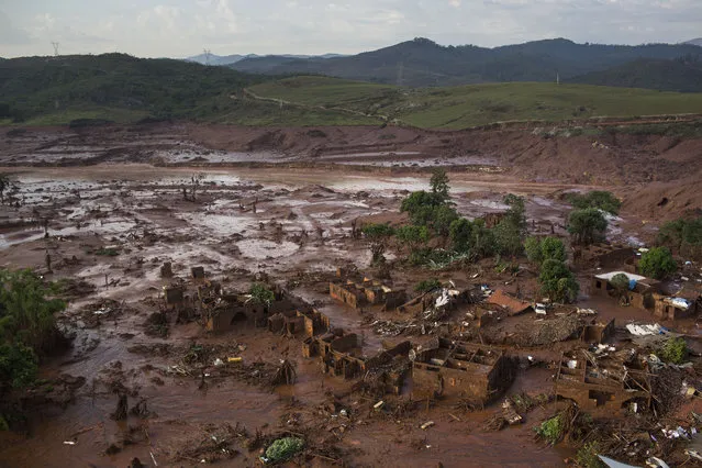 Aerial view of the debris after a dam burst at the small town of Bento Rodrigues in Minas Gerais state, Brazil, Friday, November 6, 2015. (Photo by Felipe Dana/AP Photo)