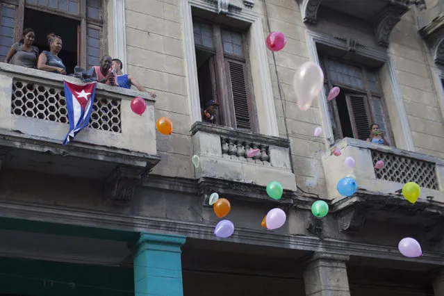 People release balloons during the annual procession of Our Lady of Charity, the patron saint of Cuba, on the streets of downtown Havana September 8, 2014. (Photo by Alexandre Meneghini/Reuters)