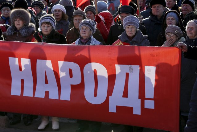 Activists and supporters of the Communist Party take part in a demonstration marking the anniversary of the 1917 Bolshevik revolution also known as known as the Great October Socialist Revolution in the Siberian city of Krasnoyarsk, Russia, November 7, 2015. The banner reads, "People!". (Photo by Ilya Naymushin/Reuters)