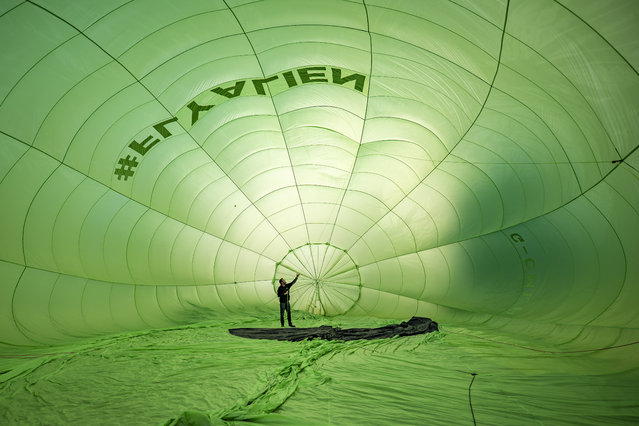 Balloon pilots check interior canopy rigging as they prepare for flight on College Green, Bristol, UK on Friday, July 25, 2025, during a preview of the 47th Bristol International Balloon Fiesta, an annual four day free festival of hot air ballooning and the largest event of its kind in Europe, that is due to take between August 8 and 10 in Bristol. (Photo by Ben Birchall/PA Wire)