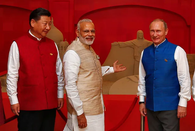 (L-R) Chinese President Xi Jinping, Indian Prime Minister Narendra Modi and Russian President Vladimir Putin pose infront of a sand sculpture ahead of BRICS (Brazil, Russia, India, China and South Africa) Summit in Benaulim, in the western state of Goa, India, October 15, 2016. (Photo by Danish Siddiqui/Reuters)