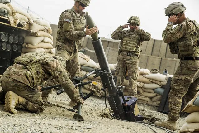 U.S. soldiers from the 3rd Cavalry Regiment fire a 120mm mortar during an exercise on forward operating base Gamberi in the Laghman province of Afghanistan December 24, 2014. (Photo by Lucas Jackson/Reuters)