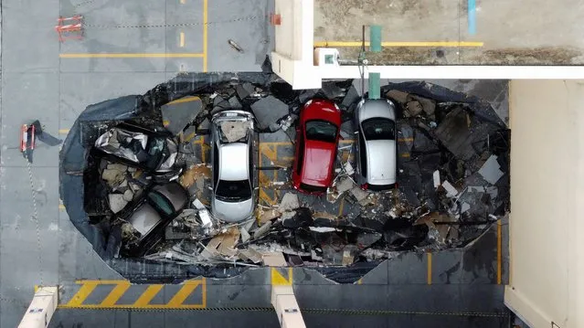 Drone view of vehicles after part of the ceiling collapsed in a mall in Osasco, Brazil on March 9, 2023. (Photo by Carla Carniel/Reuters)