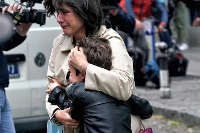 A parent escorts her child following a shooting at a school in the capital Belgrade on May 3, 2023. Serbian police arrested a student following a shooting at an elementary school in the capital Belgrade on May 3, 2023, the interior ministry said. The shooting occurred at 8:40 am local time (06:40 GMT) at an elementary school in Belgrade's downtown Vracar district. (Photo by Oliver Bunic/AFP Photo)