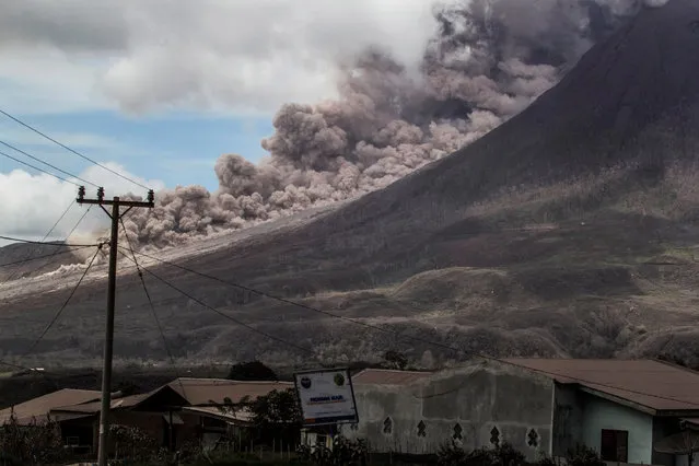 Photo taken on November 2, 2016 shows volcanic ash spewing from Mount Sinabung during an eruption seen from Karo district, North Sumatra, Indonesia. Mount Sinabung roared back to life in 2010 for the first time during 400 years. After another period of inactivity, it erupted once more in 2013 and remained highly active since then. (Photo by Albert Damanik/Barcroft Images)
