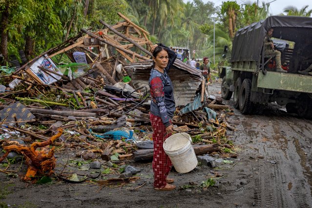 A resident looks on next to a house destroyed by storm surges brought about by Super Typhoon Fung-wong on November 10, 2025 in Dipaculao, Aurora province, Philippines. (Photo by Ezra Acayan/Getty Images)