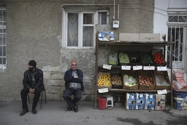 In this Thursday, May 10, 2018 photo, a fruit vendor sits outside his shop in Stepanakert. Since a six-year separatist war ended in 1994, the mountainous region of Nagorno-Karabakh has been controlled by local ethnic Armenian forces backed by Armenia, yet the territory continues to be claimed by neighboring Azerbaijan which has fought all attempts by the self-proclaimed Republic of Artsakh for international recognition. For the fiercely proud people of Nagorno-Karabakh, life in political limbo has meant restrictions on travel, trade, economic development and education opportunities for its youth. (Photo by Thanassis Stavrakis/AP Photo)