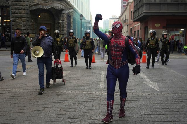 A demonstrator dressed in a Spiderman costume takes part in a march calling on the government to take stronger action to control fires in the country's Amazon region, in Lima, Peru, Wednesday, September 18, 2024. (Photo by Guadalupe Pardo/AP Photo)