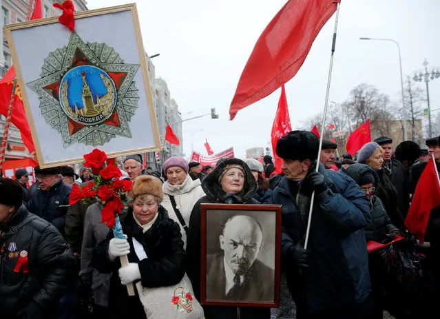 Russian communist supporters carry flags and a portrait of Soviet state founder Vladimir Lenin during a rally marking the anniversary of the 1917 Bolshevik revolution in central Moscow, Russia, November 7, 2016. (Photo by Maxim Shemetov/Reuters)