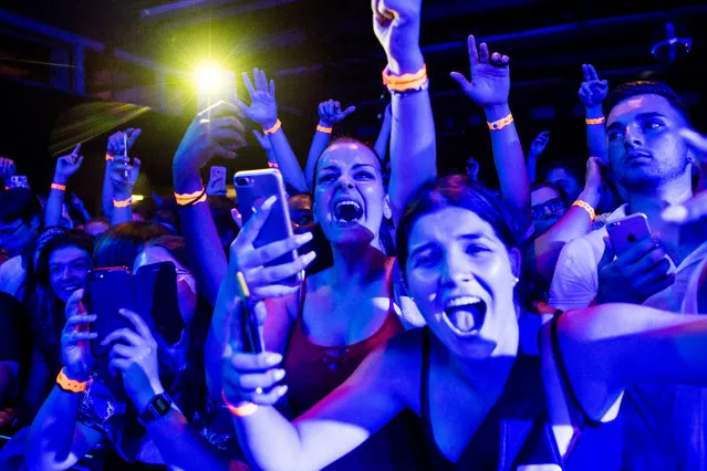 Festival-goers cheer for the concert of French rapper Moha La Squale as he performs on the stage of the Montreux Jazz Lab during the 52nd Montreux Jazz Festival, in Montreux, Switzerland, 30 June 2018. The event running from 29 June to 14 July will feature 380 concerts. (Photo by Jean-Christophe Bott/EPA/EFE)