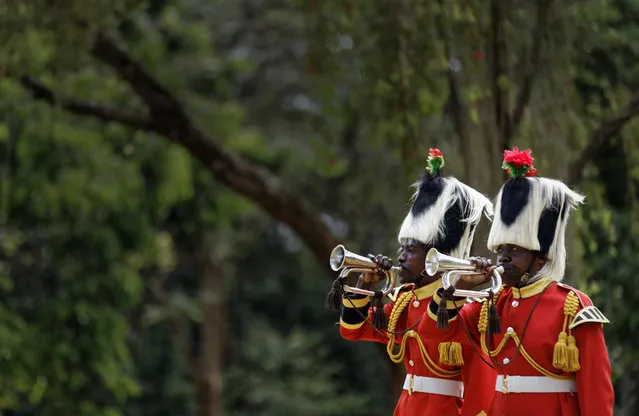 Members of a Kenyan military band sound bugles to mark the start of two minutes' silence on Remembrance Sunday at the Nairobi War Cemetery in Kenya Sunday, November 13, 2016. The annual event is observed in Britain and around the Commonwealth to honor the contribution of those British and Commonwealth military who died in the two World Wars and later conflicts. (Photo by Ben Curtis/AP Photo)