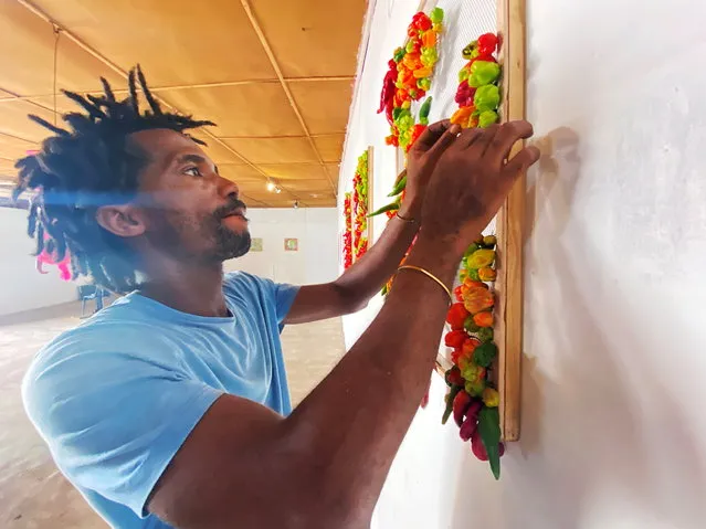 Nigerian artist Olufela Omokeko sets up an exhibition of fresh pepper motive at a gallery in Iwaya, Lagos, Nigeria on January 30, 2021. (Photo by Seun Sanni/Reuters)