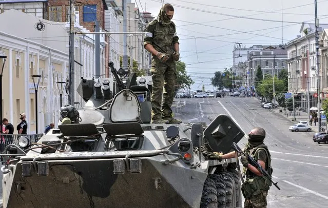 Servicemen from Private military company (PMC) Wagner Group block a street in downtown Rostov-on-Don, southern Russia, 24 June 2023. Security and armoured vehicles were deployed after private military company (PMC) Wagner Group's chief Yevgeny Prigozhin said in a video that his troops had occupied the building of the headquarters of the Southern Military District, demanding a meeting with Russia's defense chiefs. (Photo by Arkady Budnitsky/EPA)