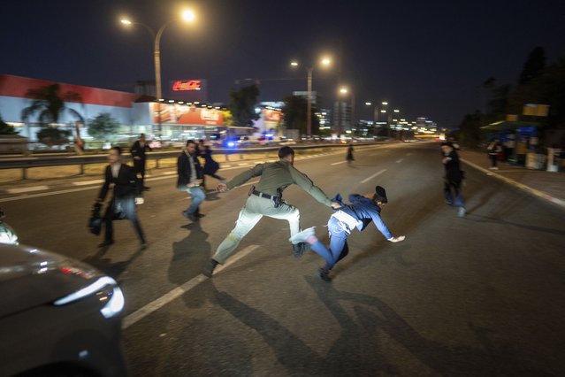 Israeli police disperse Ultra-Orthodox Jewish men blocking a highway to protest against army recruitment in Bnei Brak, Israel, Thursday, January 9, 2025. (Photo by Oded Balilty/AP Photo)