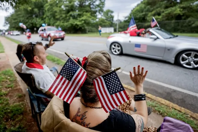 Spectators watch the Fourth of July Parade on US Independence Day in Avondale Estates, Georgia, USA, 04 July 2023. The parade celebrates the 247th anniversary of the United States breaking off from Great Britain in 1776. (Photo by Erik S. Lesser/EPA)